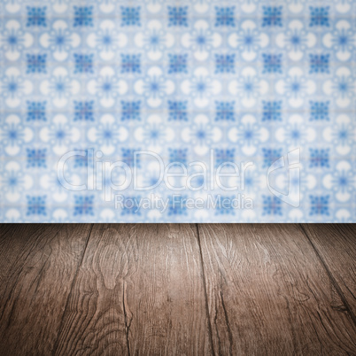 Wood table top and blur vintage ceramic tile pattern wall