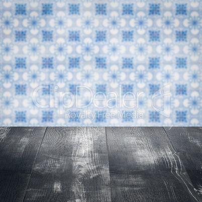 Wood table top and blur vintage ceramic tile pattern wall