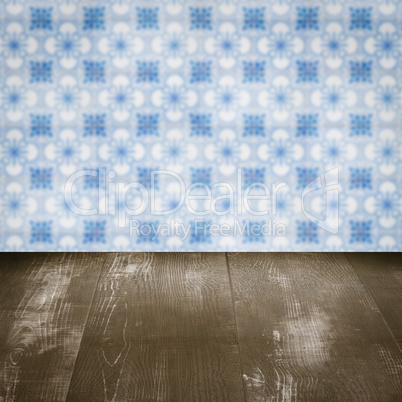 Wood table top and blur vintage ceramic tile pattern wall