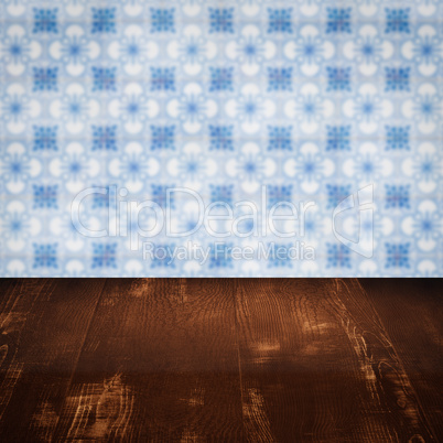 Wood table top and blur vintage ceramic tile pattern wall Wood table top and blur vintage ceramic tile pattern wall