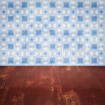 Wood table top and blur vintage ceramic tile pattern wall