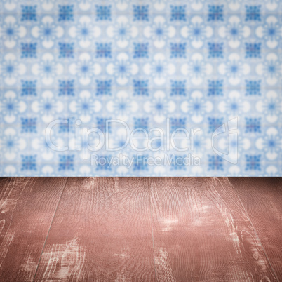 Wood table top and blur vintage ceramic tile pattern wall Wood table top and blur vintage ceramic tile pattern wall