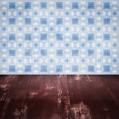 Wood table top and blur vintage ceramic tile pattern wall