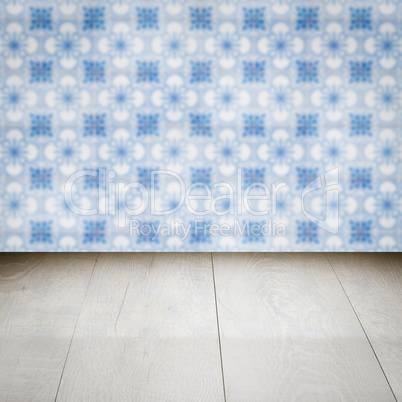 Wood table top and blur vintage ceramic tile pattern wall