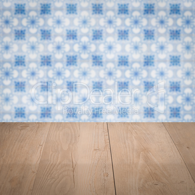 Wood table top and blur vintage ceramic tile pattern wall
