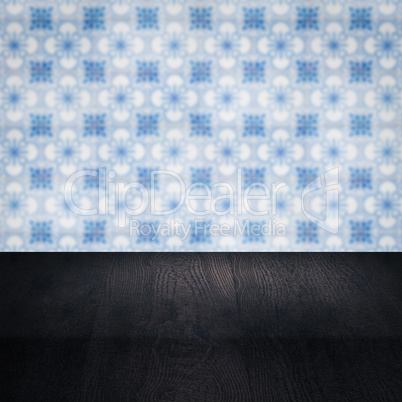 Wood table top and blur vintage ceramic tile pattern wall