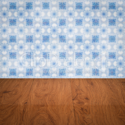 Wood table top and blur vintage ceramic tile pattern wall