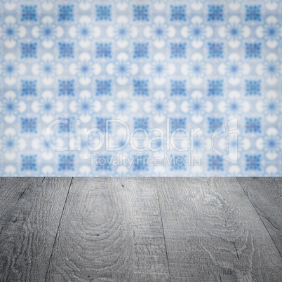 Wood table top and blur vintage ceramic tile pattern wall