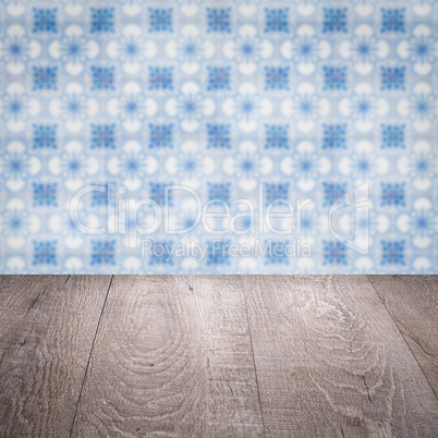 Wood table top and blur vintage ceramic tile pattern wall