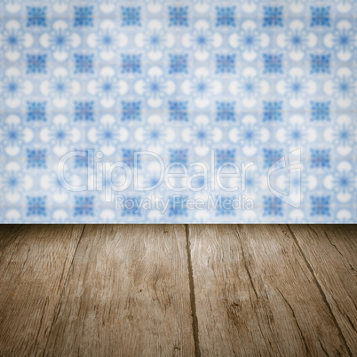 Wood table top and blur vintage ceramic tile pattern wall