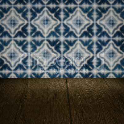 Wood table top and blur vintage ceramic tile pattern wall