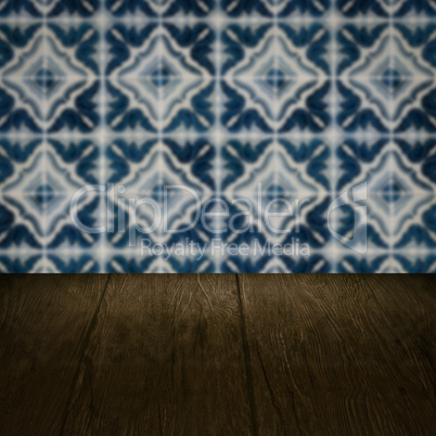 Wood table top and blur vintage ceramic tile pattern wall