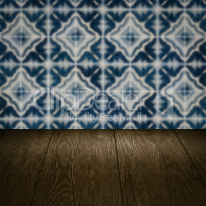 Wood table top and blur vintage ceramic tile pattern wall