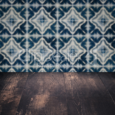 Wood table top and blur vintage ceramic tile pattern wall Wood table top and blur vintage ceramic tile pattern wall
