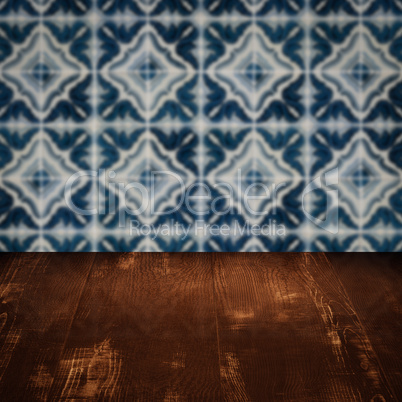 Wood table top and blur vintage ceramic tile pattern wall