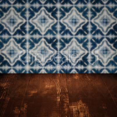 Wood table top and blur vintage ceramic tile pattern wall Wood table top and blur vintage ceramic tile pattern wall