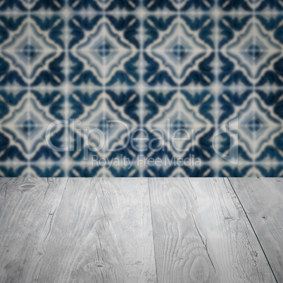 Wood table top and blur vintage ceramic tile pattern wall