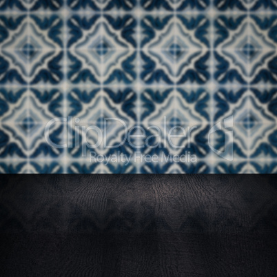 Wood table top and blur vintage ceramic tile pattern wall