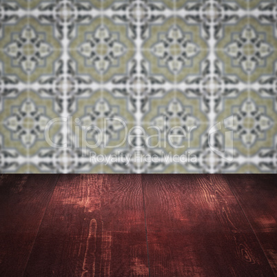 Wood table top and blur vintage ceramic tile pattern wall Wood table top and blur vintage ceramic tile pattern wall