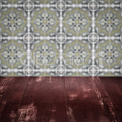 Wood table top and blur vintage ceramic tile pattern wall