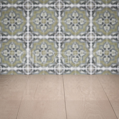 Wood table top and blur vintage ceramic tile pattern wall