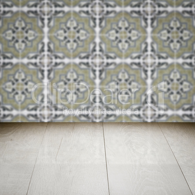 Wood table top and blur vintage ceramic tile pattern wall Wood table top and blur vintage ceramic tile pattern wall