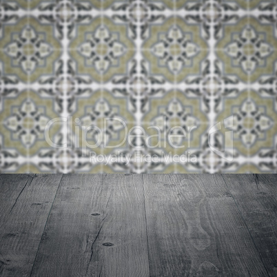 Wood table top and blur vintage ceramic tile pattern wall