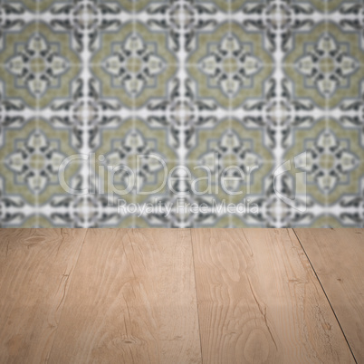 Wood table top and blur vintage ceramic tile pattern wall