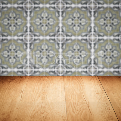 Wood table top and blur vintage ceramic tile pattern wall