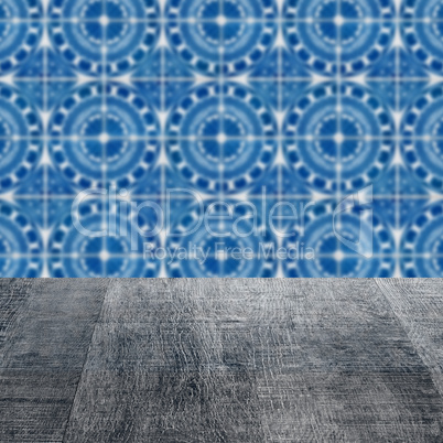 Wood table top and blur vintage ceramic tile pattern wall