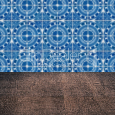 Wood table top and blur vintage ceramic tile pattern wall Wood table top and blur vintage ceramic tile pattern wall