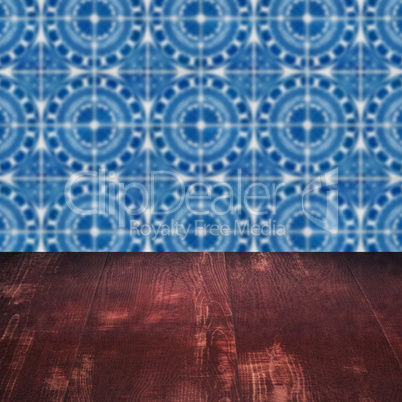 Wood table top and blur vintage ceramic tile pattern wall