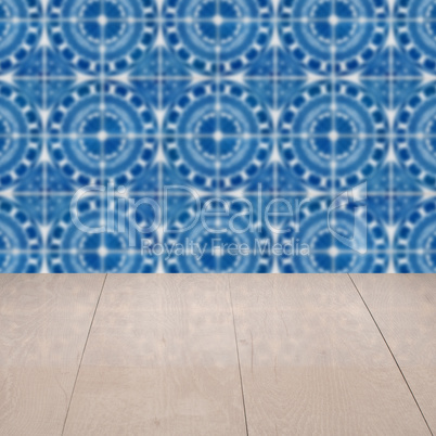 Wood table top and blur vintage ceramic tile pattern wall