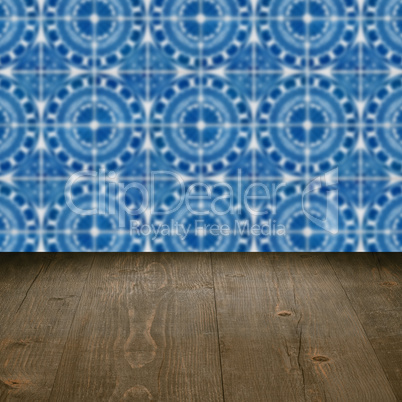 Wood table top and blur vintage ceramic tile pattern wall