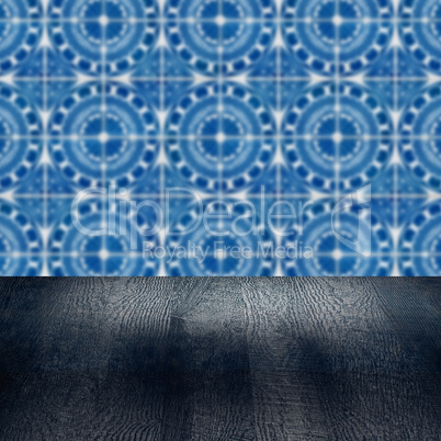 Wood table top and blur vintage ceramic tile pattern wall