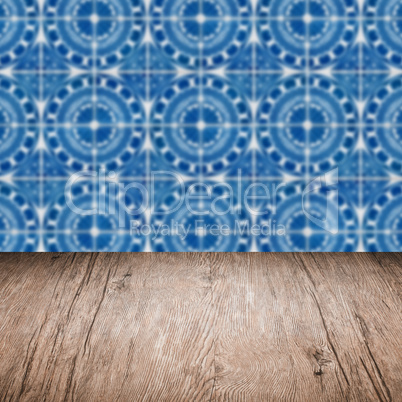 Wood table top and blur vintage ceramic tile pattern wall