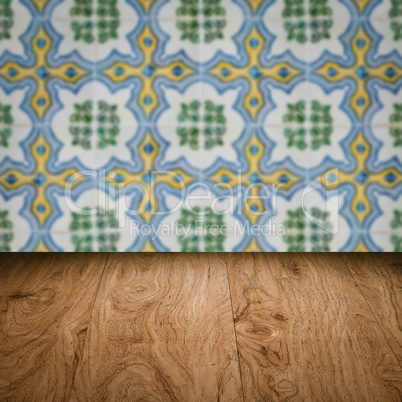 Wood table top and blur vintage ceramic tile pattern wall