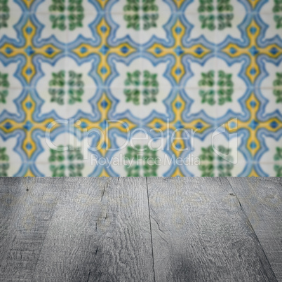 Wood table top and blur vintage ceramic tile pattern wall