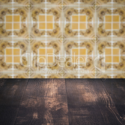 Wood table top and blur vintage ceramic tile pattern wall