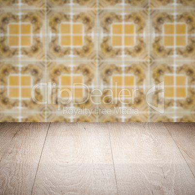 Wood table top and blur vintage ceramic tile pattern wall