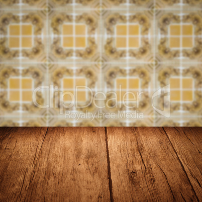 Wood table top and blur vintage ceramic tile pattern wall