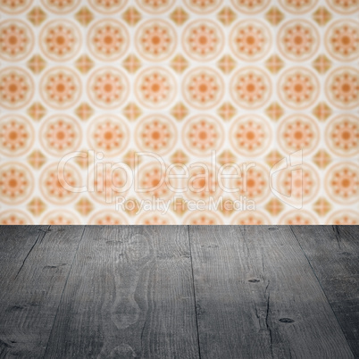 Wood table top and blur vintage ceramic tile pattern wall