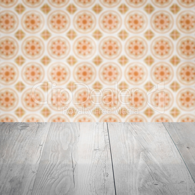 Wood table top and blur vintage ceramic tile pattern wall