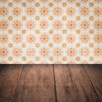 Wood table top and blur vintage ceramic tile pattern wall Wood table top and blur vintage ceramic tile pattern wall