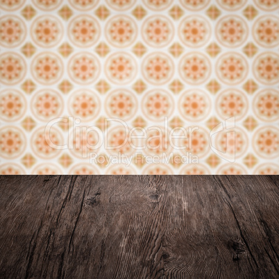 Wood table top and blur vintage ceramic tile pattern wall