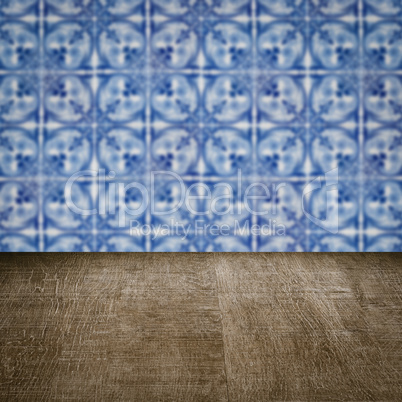 Wood table top and blur vintage ceramic tile pattern wall