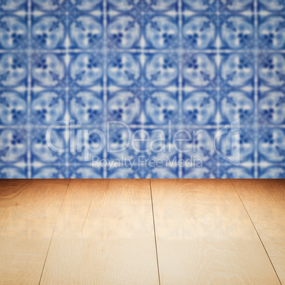 Wood table top and blur vintage ceramic tile pattern wall