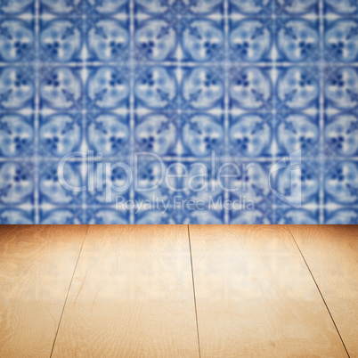 Wood table top and blur vintage ceramic tile pattern wall