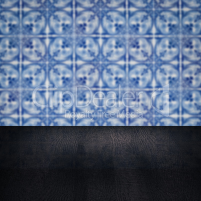 Wood table top and blur vintage ceramic tile pattern wall