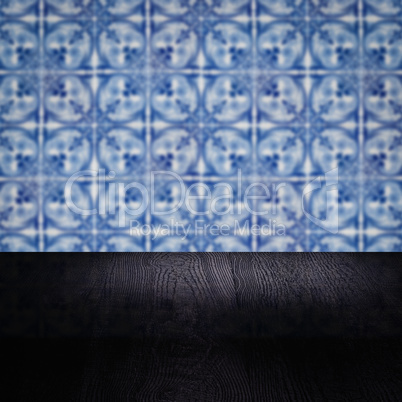 Wood table top and blur vintage ceramic tile pattern wall